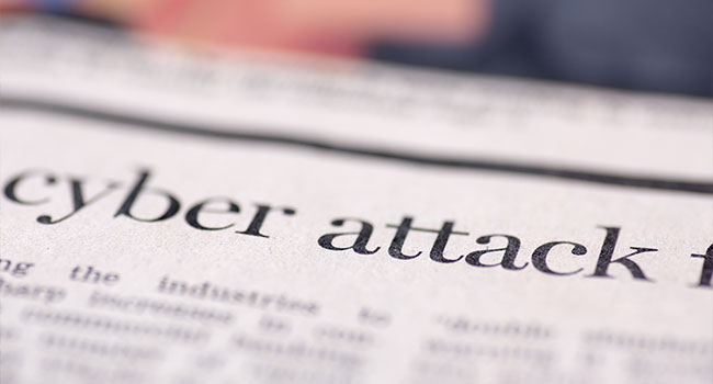 cyber attack written on newspaper