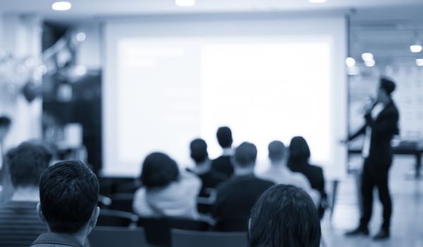 Corporate seminar with expert speaker presenting to people