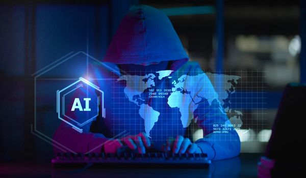 Person in hood typing on computer