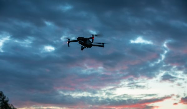 Drone flying at sunset
