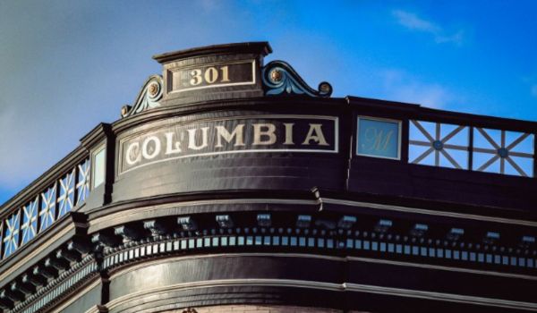 Ornate building with “Columbia” and “301” displayed against a blue sky.