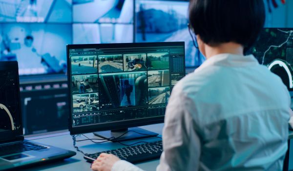 A woman reviews public surveillance footage.