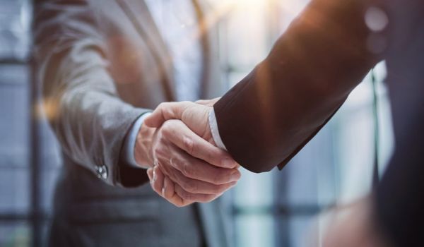Two businessmen shake hands.