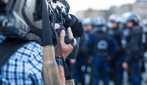 the cameraman captures the events on the streets live television