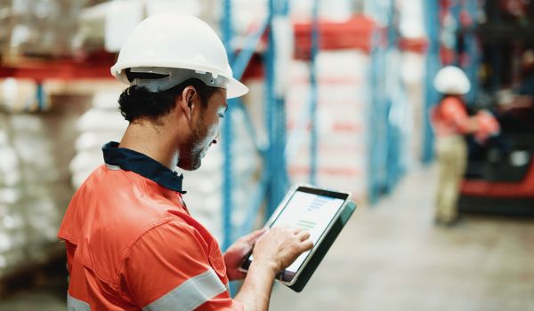 Factory worker looking at data on tablet