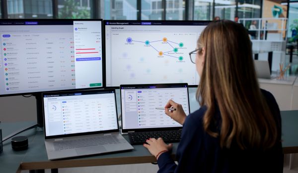 Woman uses a laptop to manage user access.