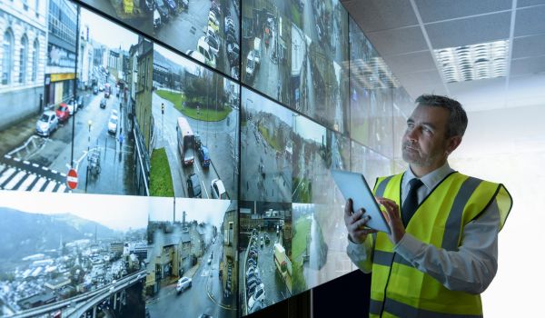 Man looking at multiple monitors