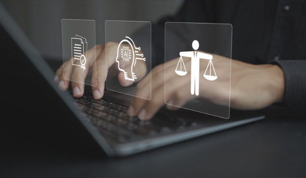 Person typing on a laptop with digital overlays representing artificial intelligence, compliance and accountability.