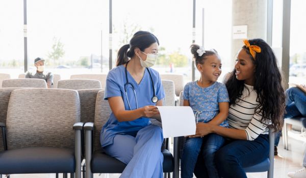 Doctor speaking to patients in hospital