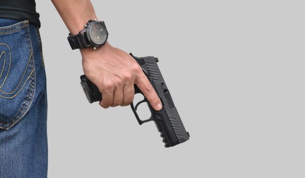 Isolated 9mm pistol gun holding in right hand of gun shooter with clipping paths.