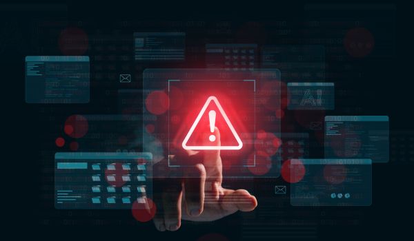 Warning alert icon with a hacked system