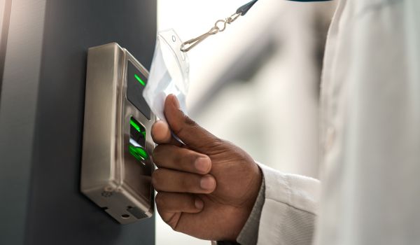 Person scanning badge to access building 