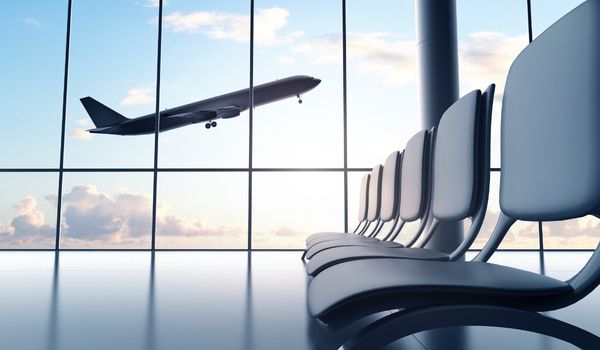 plane flying outside of airport window
