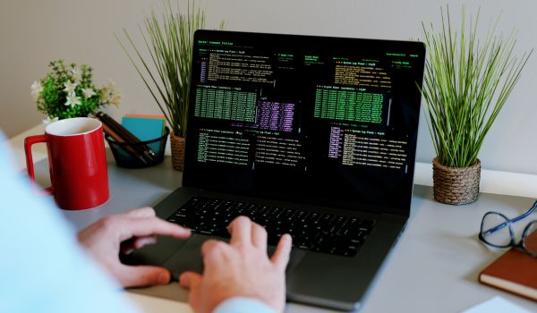 Person performing penetration testing on laptop