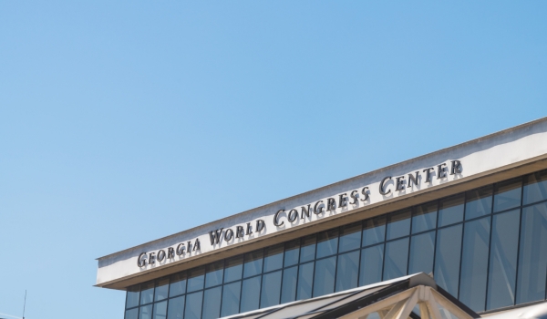 Exterior view of the Georgia World Congress Center venue building against a clear blue sky.