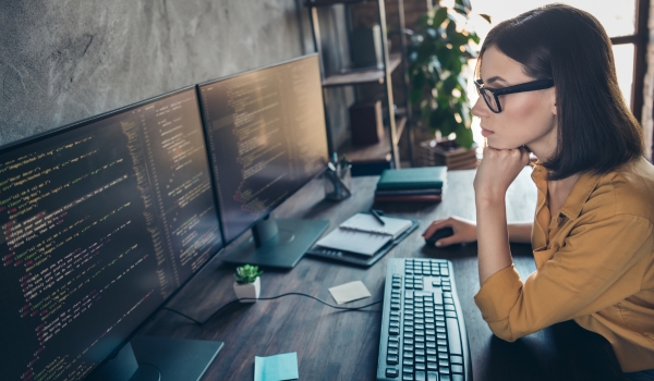 Profile side view portrait of attractive clever smart girl cyber engineer analyzing html css php framework at workplace workstation indoors