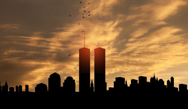 New York skyline silhouette with Twin Towers and birds flying up like souls at sunset. 09.11.2001 American Patriot Day