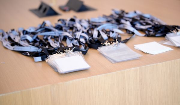 Blank conference badges waiting on registration desk