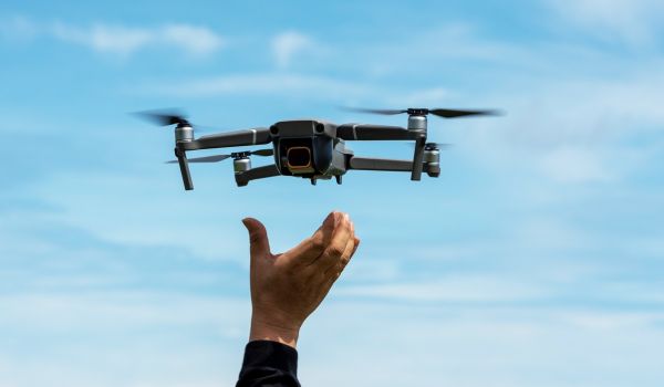 Person reaching for drone 