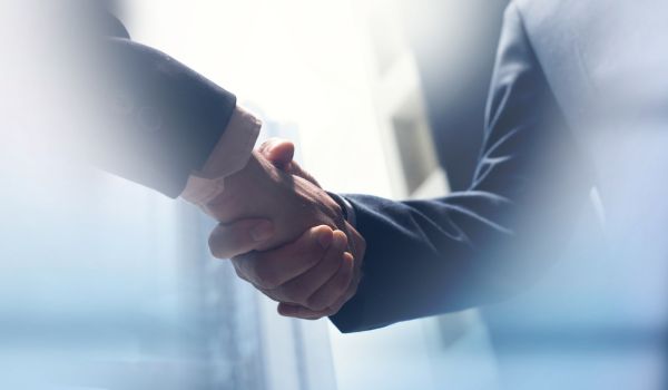 Businessmen making handshake with partner