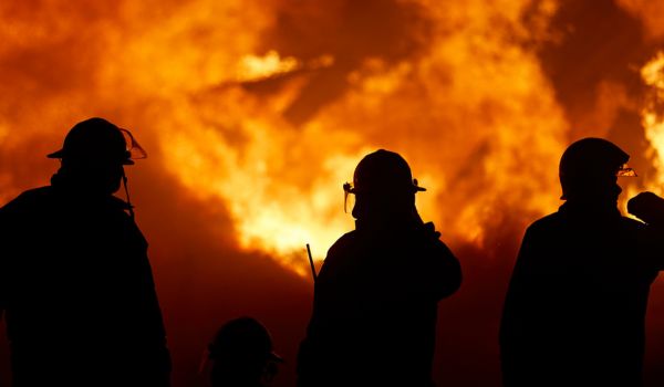 Firefighters with fire in the background