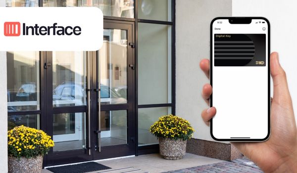 Person holding smartphone in front of building