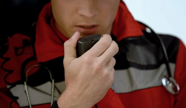 Male doctor responds by radio in ambulance