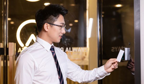 Businessman swiping access card at office entrance