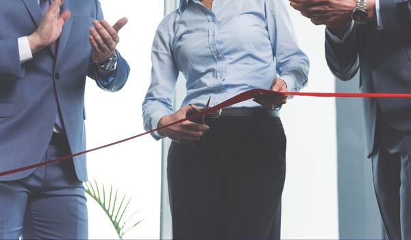 Group of professionals cutting banner
