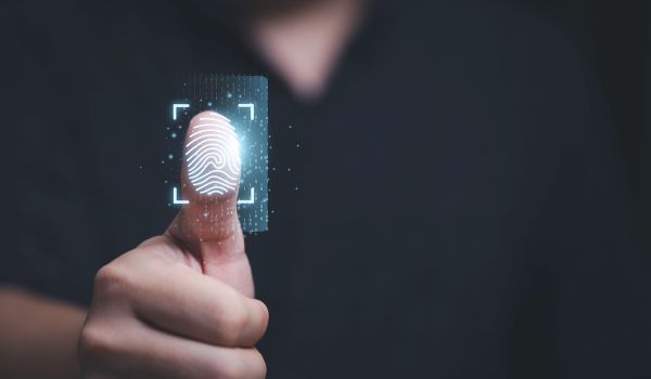 Person scanning finger on biometrics graphic overlay