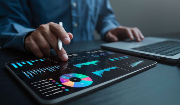 An analyst uses a computer and dashboard for data business analysis