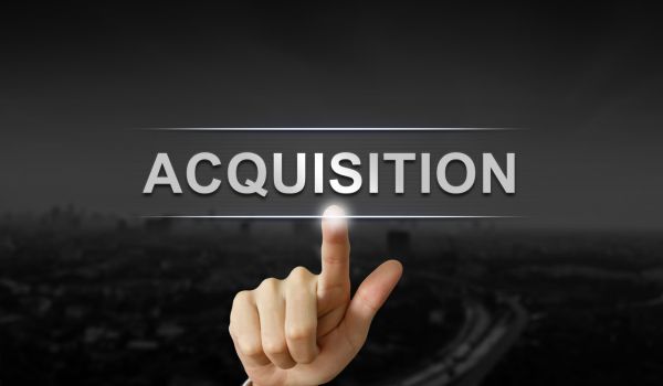 business hand pushing acquisition button