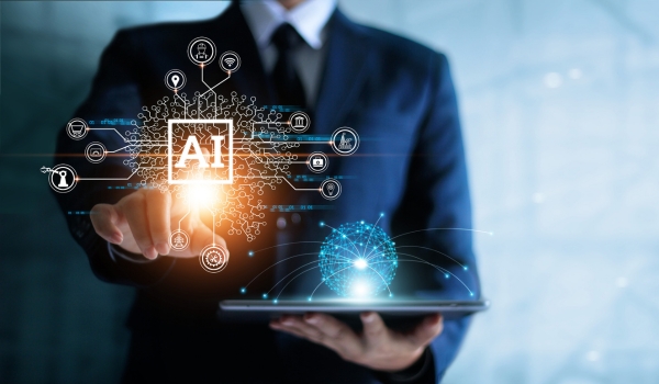A business professional in a suit interacting with a glowing digital AI interface connected to various industry icons and a digital globe above a tablet.