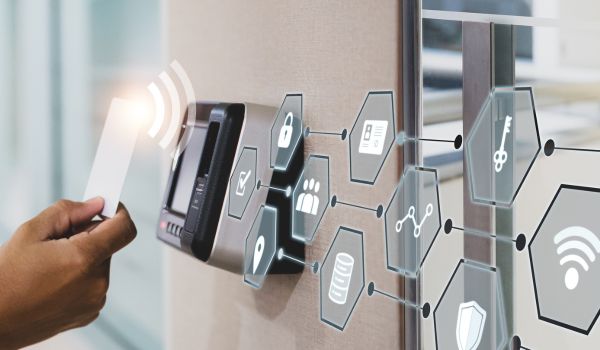 security man using fingerprint scan on ID card reader access control system