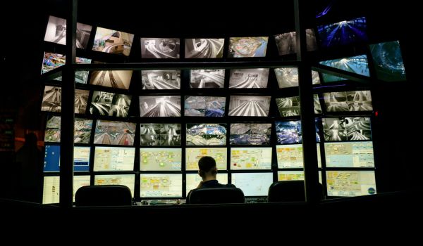 Person sitting in front of multiple screens