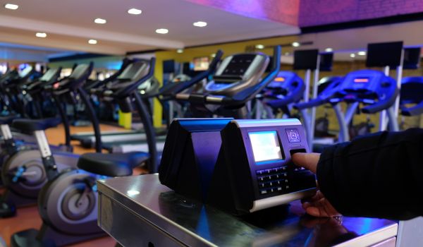 Person scanning fingerprint at the gym