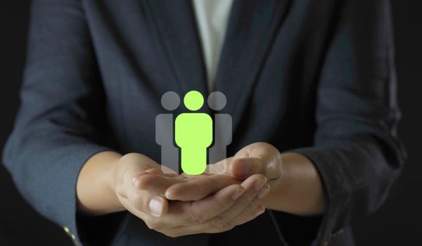 Human resources management concept with hands protecting people icon