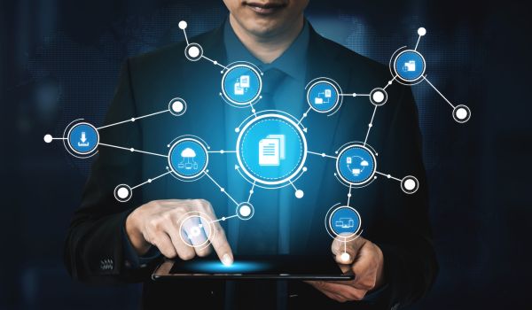 A business professional interacts with a tablet with graphic overlay