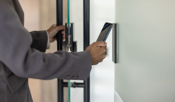 Person using cellphone to access building