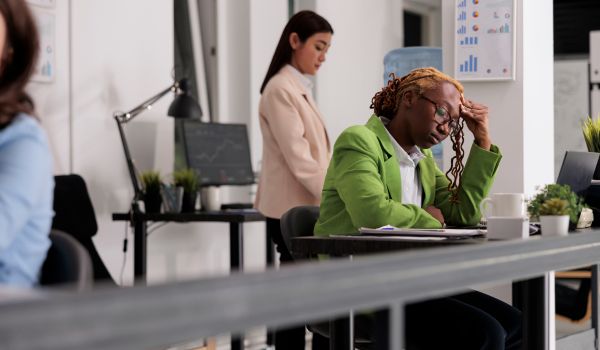 Burnt out, unhappy employee in office environment