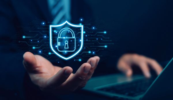 Person working on laptop with digital padlock overlay