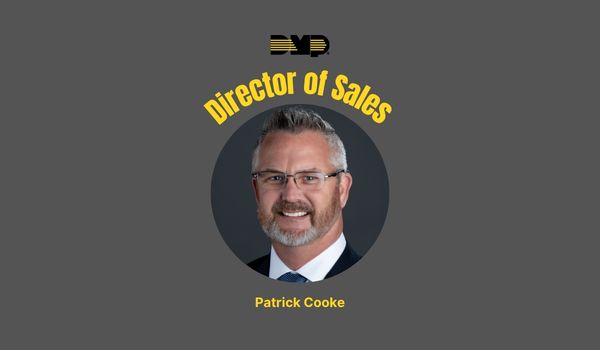 Headshot of Patrick Cooke on gray background 