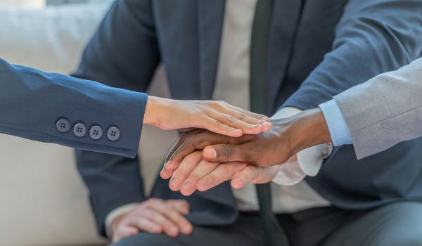 Group of people putting their hands together