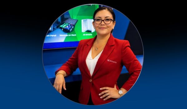 Headshot of Monica Mejia on blue background
