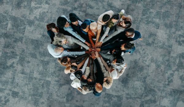 Team members with hands together