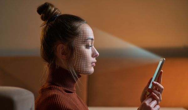 Woman using FaceID on smartphone