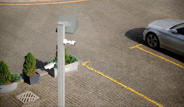 Top view surveillance camera in an open parking lot near a hotel