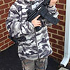Father Displays Army Fatigued Child Holding a Military Style Gun on Facebook