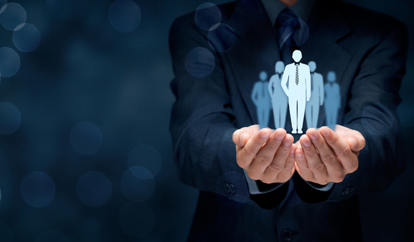 Executive presenting a leadership and team icon in his open hands