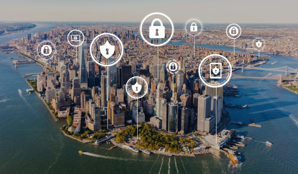 Aerial view of Lower Manhattan with overlaid padlock and shield icons representing cybersecurity and infrastructure protection.